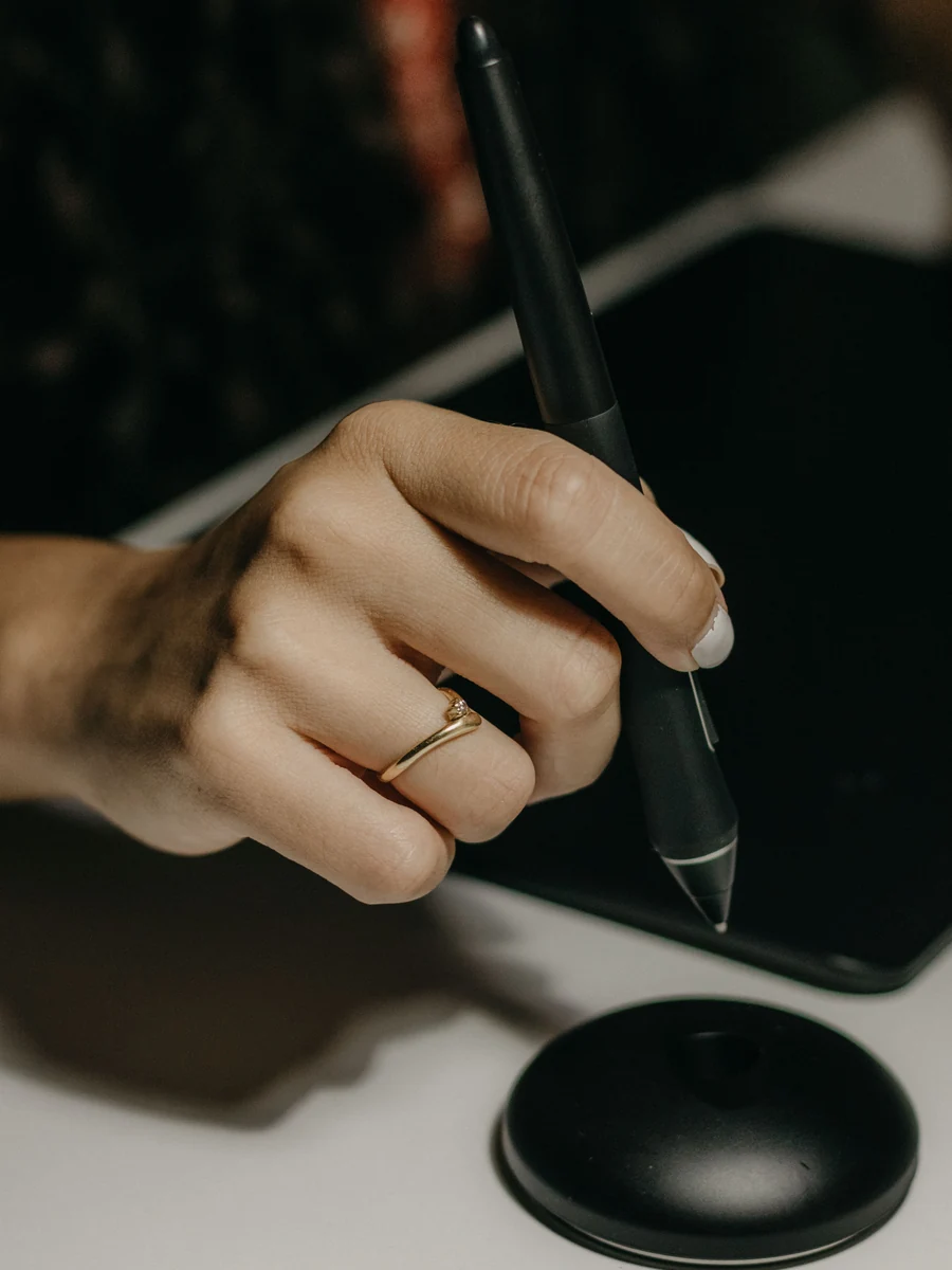 A retoucher working on a tablet, reviewing a detail during a retouching pass