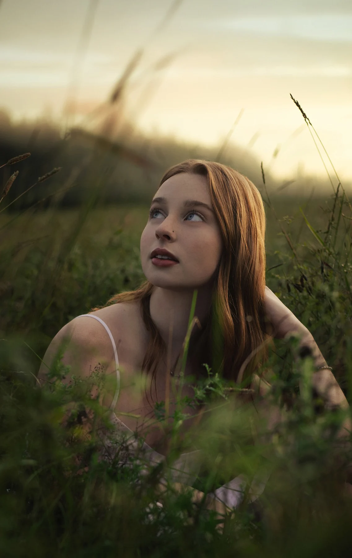 Featured portrait retouching of a woman in a sunlit field at golden hour