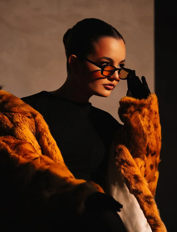 Fashion editorial portrait in a fur coat after skin and colour retouching
